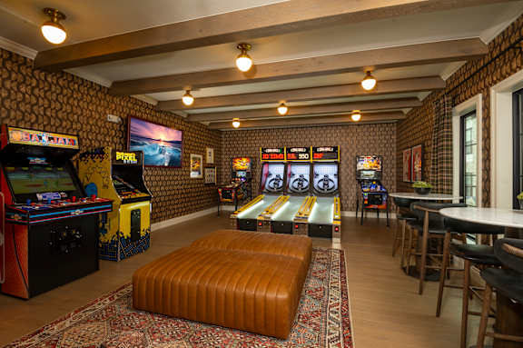 A room with a bowling alley and a pool table.