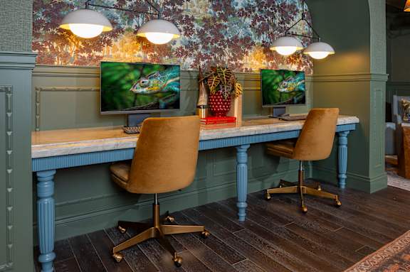 A room with a desk and two chairs.