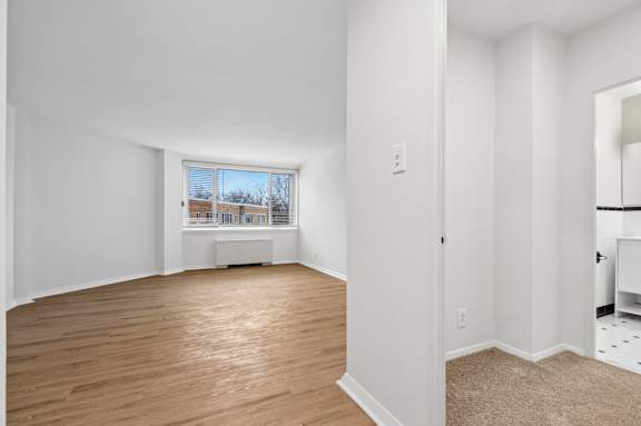A room with wooden floors and white walls.