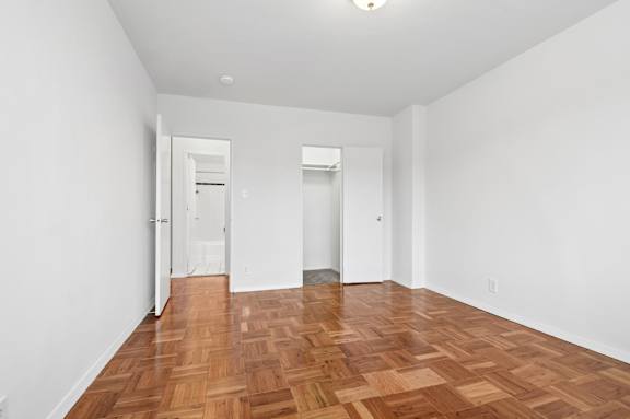 A room with wooden floors and white walls.