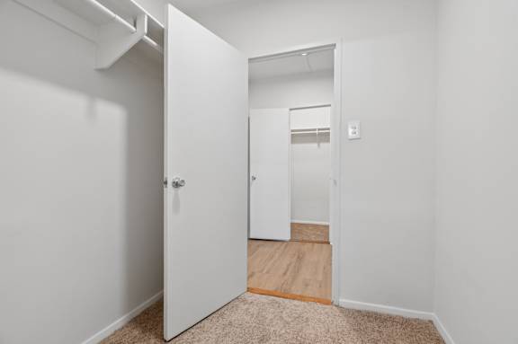 A white door is open to a hallway.