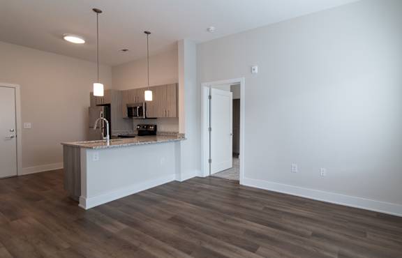 A kitchen with a white counter and a white door.