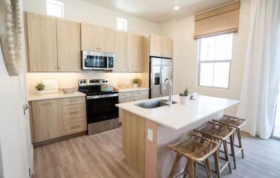 a kitchen with wooden cabinets and a white counter top