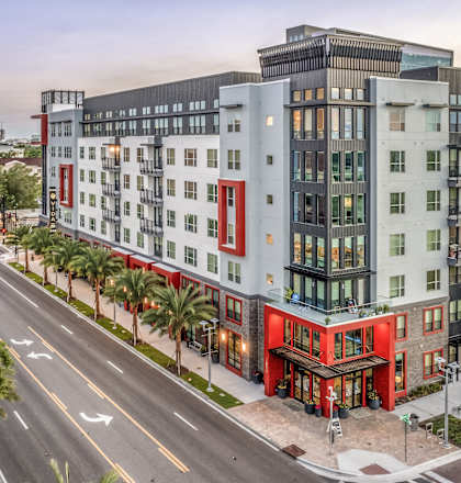 an aerial view of an apartment building on a city street