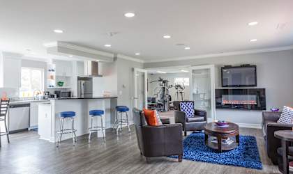 A modern living room with a bar area and a television.