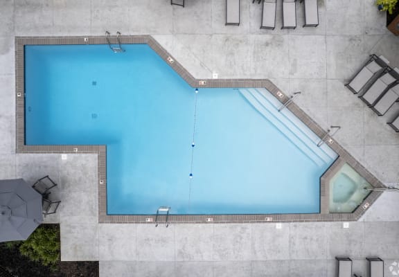 an aerial view of a swimming pool with blue water