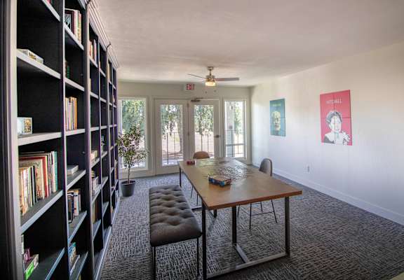 table and chairs and a bookshelf at Woodland Crossing , Woodland, CA 95695