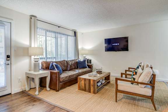 a living room with a couch and a chair and a tv