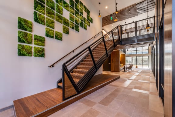 a staircase in a building with plants on the wall
