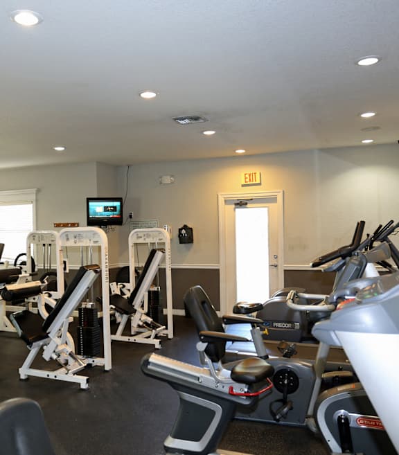 a gym with cardio machines and other exercise equipment