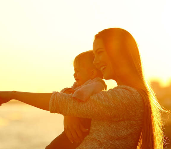A woman with a child is pointing at something.