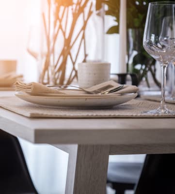 a wooden table with plates and glasses on it