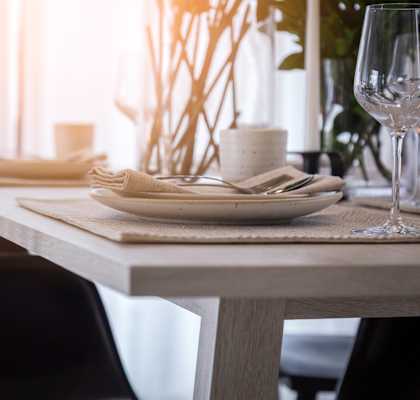 a wooden table with plates and glasses on it