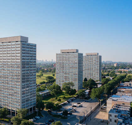 an aerial view of three tall skyscrapers in a city