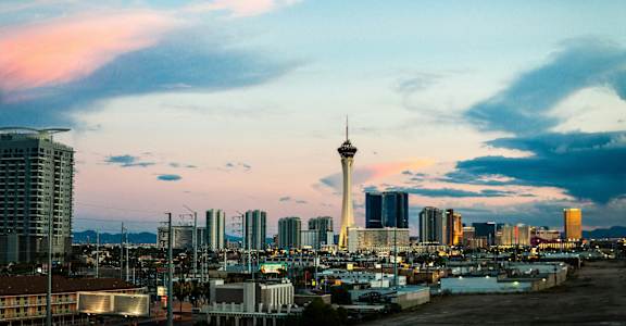 A city skyline with a tall tower in the center.