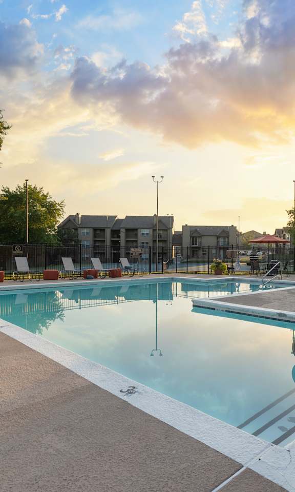 Swimming pool at The Lakes Apartments featuring a relaxing outdoor setting.