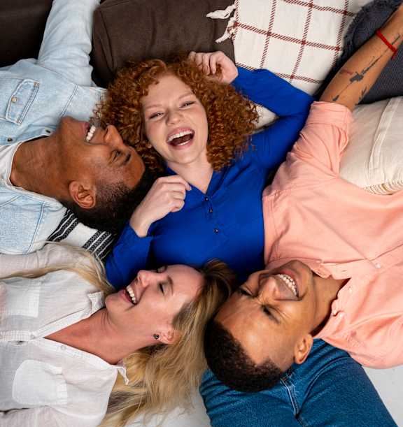 Group of people lying down and laughing at Brickside Heights, Millcreek, UT