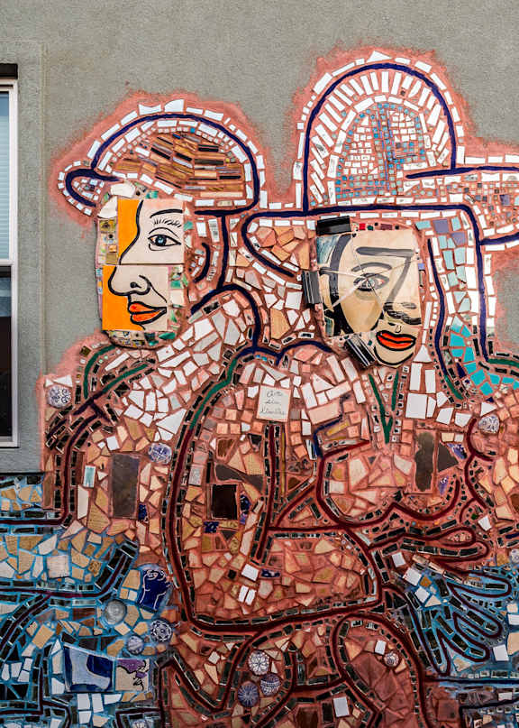 A mural of two women with a cityscape in the background.