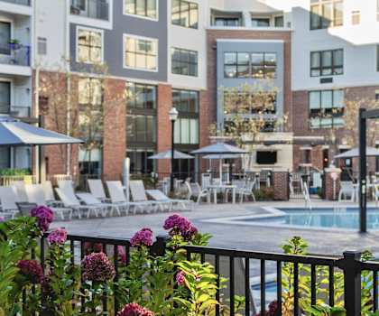 a swimming pool in front of an apartment building