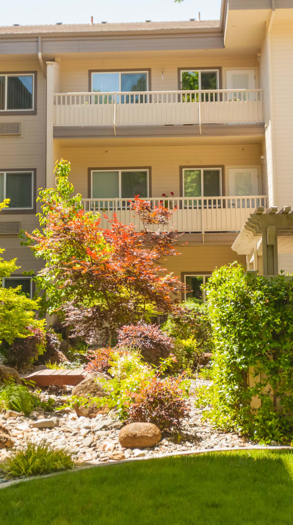 a lobby with couches and chairs and a table in the middle at River Commons Senior Living, Redding