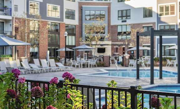 a swimming pool in front of an apartment building