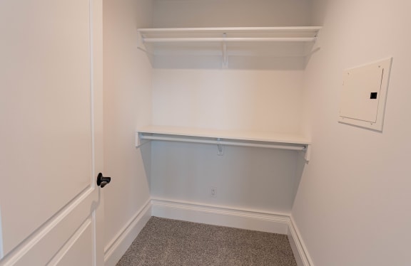 an empty closet in a home with white walls and a white door at Vendome Place, San Jose