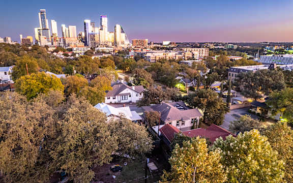 A cityscape with a mix of residential and commercial buildings.