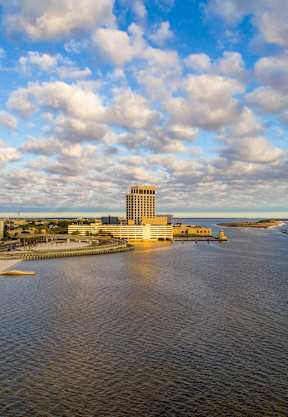 A large body of water with a building in the distance.