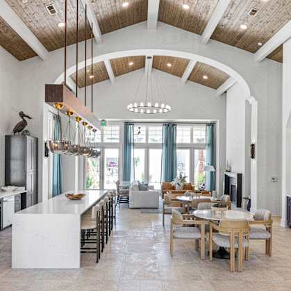 A modern kitchen with a dining table and chairs.