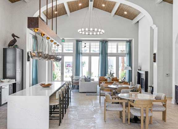 A modern kitchen with a dining table and chairs.