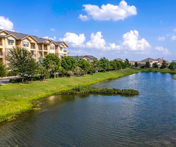 a view of a lake near a building at Las Brisas Apartment Homes, Round Rock, 78665