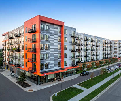 a large apartment building with an orange facade and balconies