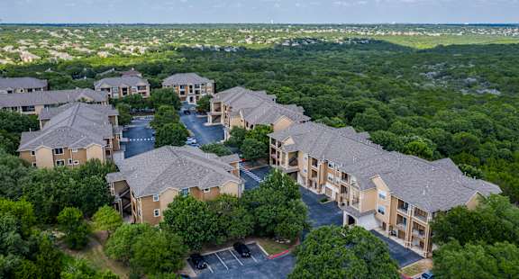 A bird's eye view of a resort surrounded by trees.