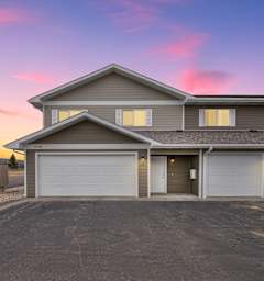 A house with a driveway in front of it.
