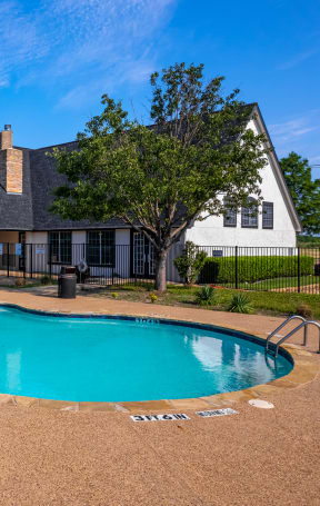 a swimming pool with a house in the background