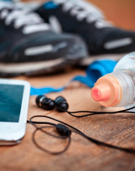 a pair of sneakers and a bottle of water and a cell phone