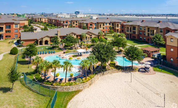 an aerial view of an apartment complex with a swimming pool