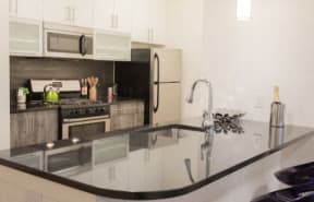 a kitchen with a large counter top and a stove top oven