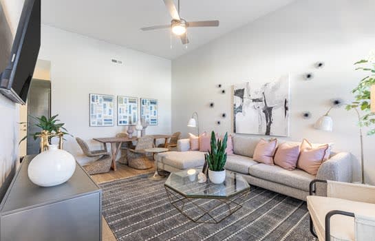 a living room filled with furniture and a flat screen tv