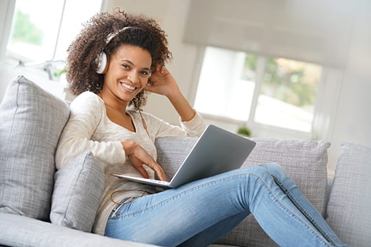 Woman on couch with laptop