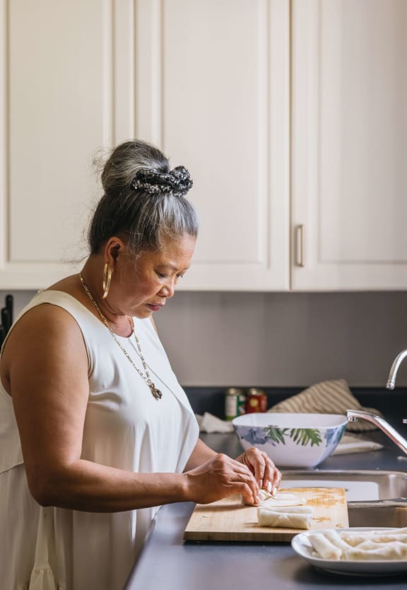 Lady Cooking at Hadley Apartments - A 55+ Lifestyle Community