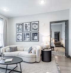 a living room with a couch and a coffee table at The Louis Apartment Flats, Louisville, KY