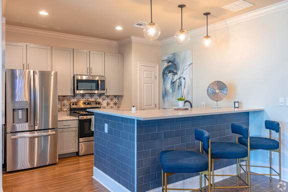 a dining room and kitchen with a table and chairs at Reserve Of Bossier City Apartment Homes in Bossier City, Louisiana 71111