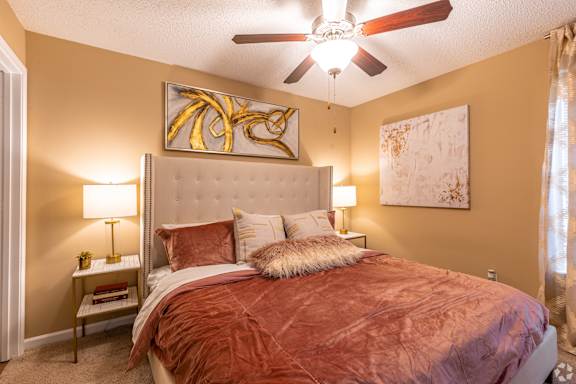 a swimming pool with chaise lounge chairs and a pool house in the background at Reserve Of Bossier City Apartment Homes in Bossier City, LA 71111