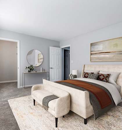 a bedroom with a bed and a chair in a 555 waverly unit