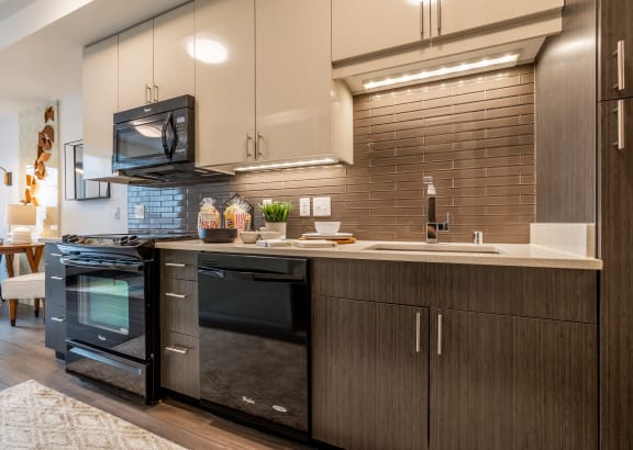Kitchen and Dining Area with Stainless Steel Appliances and Hardwood Inspired Floors