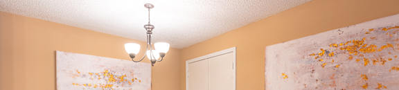 A dining room with a table set for two and two chairs at Reserve of Bossier City Apartment Homes in Bossier City, 71111