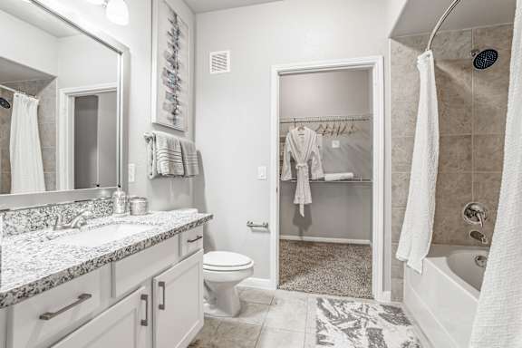 a bathroom with a shower and a sink and a toilet