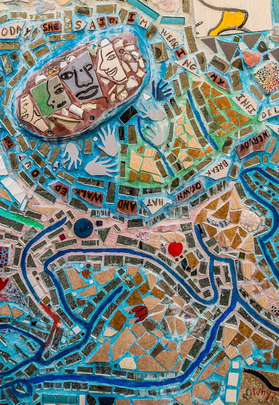 A colorful mosaic of a cityscape with roads and buildings.