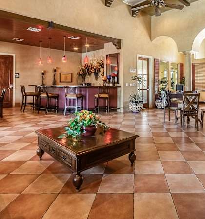 A large room with a table and chairs in it.